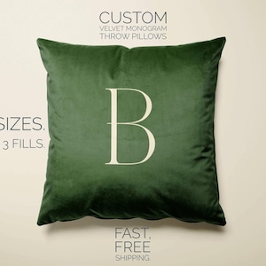 May include: A green velvet throw pillow with a white letter "B" monogram. The pillow is available in four sizes and three fills.  "CUSTOM VELVET MONOGRAM THROW PILLOWS" and "FAST, FREE SHIPPING" are printed on the image.