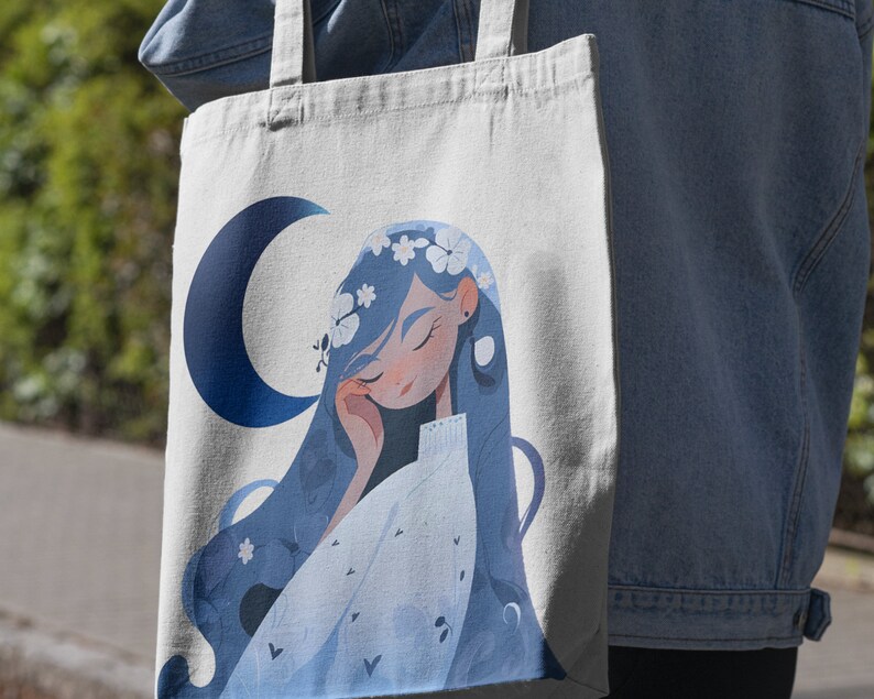 May include: A white tote bag with a blue crescent moon and a cartoon illustration of a woman with blue hair wearing a white dress and a flower crown.