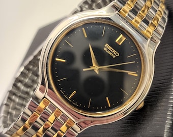 Montre Seiko rétro bicolore avec cadran noir Montre habillée classique à quartz Seiko V701 argenté et doré 1k29 Seiko