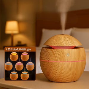 May include: A wood-grain essential oil diffuser with a dome-shaped top and a red interior. The diffuser has a power button and a pink accent line. A small display shows the LED light options. The text on the display reads "LED Colorful Mild Light".