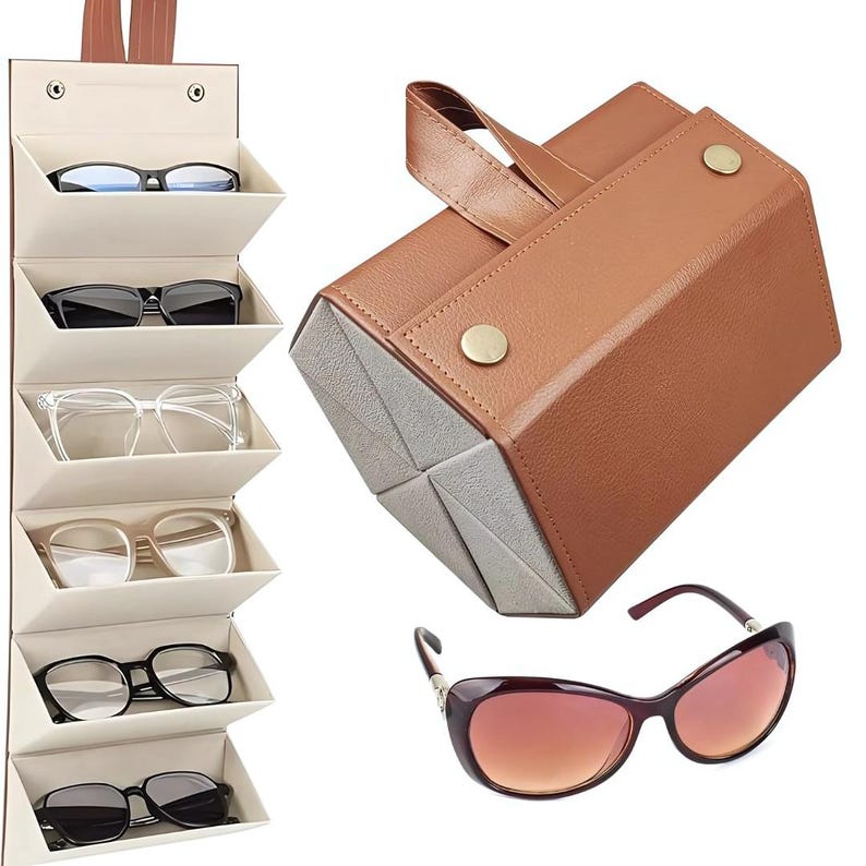 K&ouml;nnte beinhalten: Ein braunes Leder-Sonnenbrillenetui und ein h&auml;ngender Brillen-Organizer. Der Organizer ist beige mit mehreren F&auml;chern, in denen jeweils eine Brille aufbewahrt wird. Gezeigt wird auch eine Sonnenbrille mit Farbverlaufgl&auml;sern.