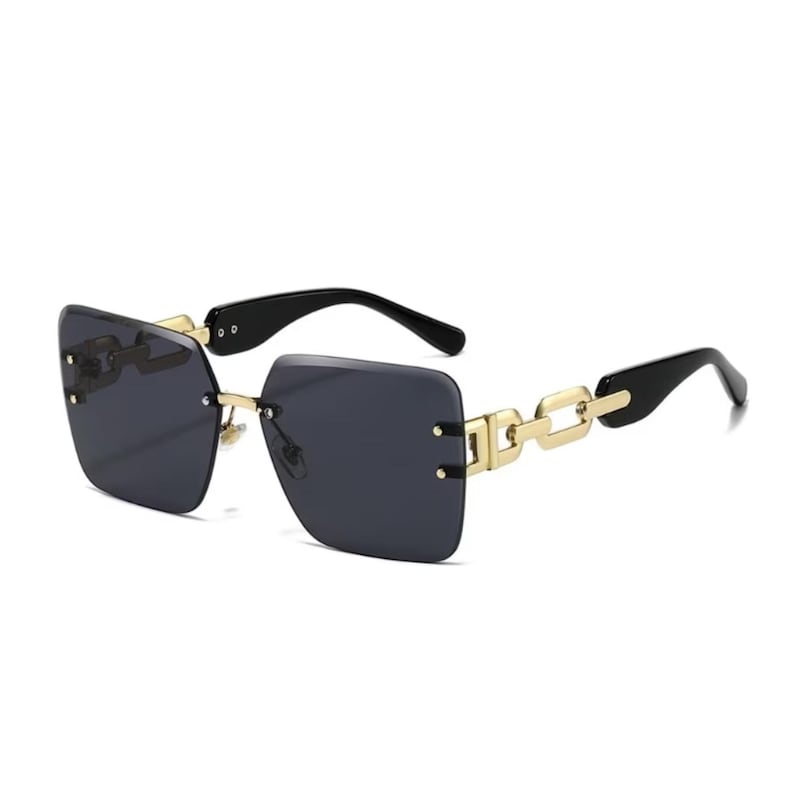 May include: Rimless sunglasses with dark gray lenses and black temples. The sunglasses feature gold-colored chain detailing on the frame. The lenses are square-shaped.