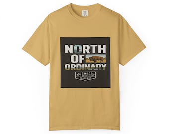 May include: Mustard yellow t-shirt with a graphic on the front. The graphic is a black square with the words "NORTH OF ORDINARY" in white. Below the text is an image of a bison and the words "NOCO FORT COLLINS COLORADO".