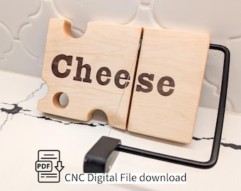May include: A light-coloured wooden cheese slicer with the word "Cheese" engraved in a dark brown font. The slicer has a wire cutting mechanism and a black handle. The design includes a PDF icon and the text "CNC Digital File download".