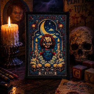 May include: A rectangular embroidered patch featuring a central illustration of a doll with red hair and blue overalls, surrounded by candles, skulls, and a crescent moon. The text THE KILLER is printed in a black box at the bottom of the design.
