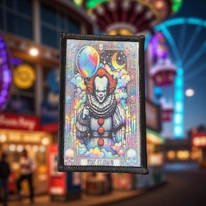 May include: A rectangular patch with a colorful illustration of a clown holding a balloon. The clown has red hair and a white face. The patch has a black border and the words "THE CLOWN" at the bottom.