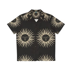 May include: A black short-sleeved button-down shirt with a repeating pattern of gold suns with closed eyes.