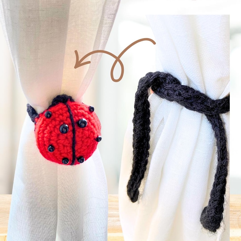 Crochet ladybug curtain tieback shown wrapped around a white curtain, with a red and black spotted ladybug on one side and black crochet ties on the other.