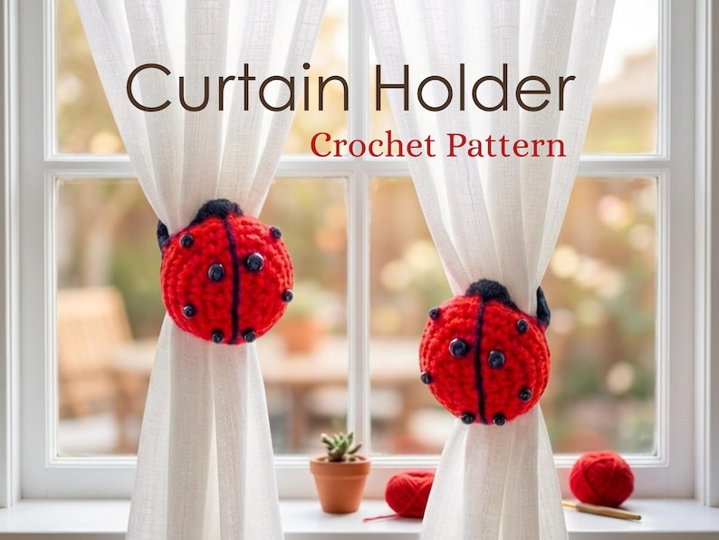 Two sheer white curtain panels gathered with matching red and black crochet ladybug tie-backs in front of a white framed window.