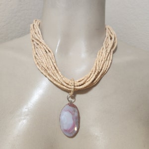 Pink swirl agate pendant on Coconut Wood Beaded Necklace