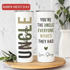 May include: Two white stainless steel tumblers with black text. One tumbler says "Uncle Patrick" in green and brown lettering. The other tumbler says "You're the uncle everyone wishes they had. Love, Stacy".