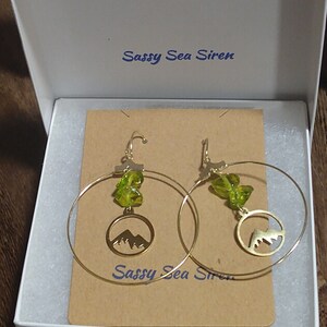 Unique mountain hoop earrings with green crystals
