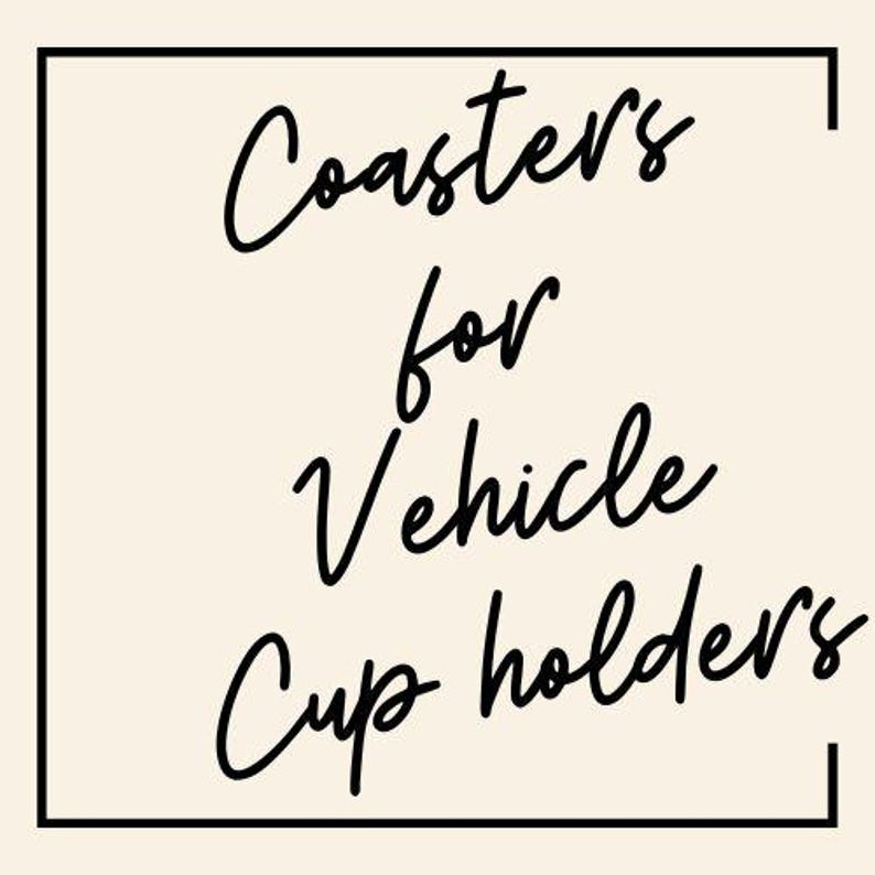 May include: Black and white text on a beige background within a black square frame. The text reads "Coasters for Vehicle Cup Holders".