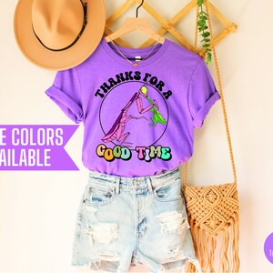 May include: Purple t-shirt with a graphic of two praying mantises and the text "Thanks for a good time".