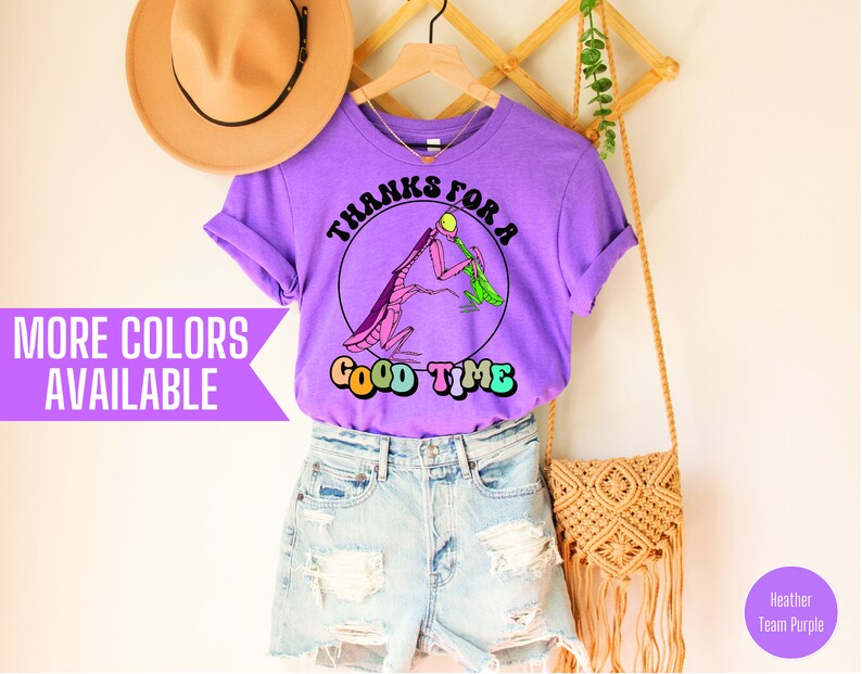 May include: Purple t-shirt with a graphic of two praying mantises and the text "Thanks for a good time".
