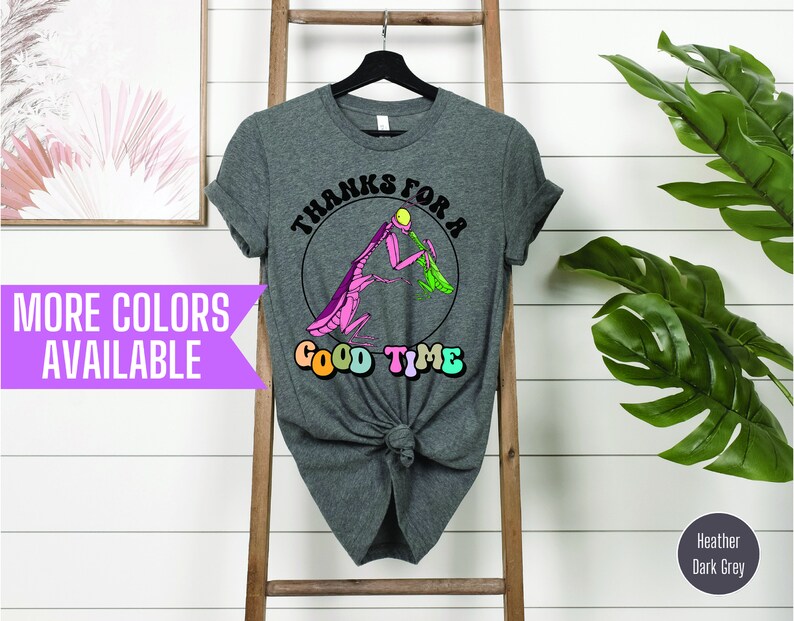 May include: A heather dark grey t-shirt with a graphic of a pink praying mantis eating a green leaf. The text "Thanks for a Good Time" is written in a retro font around the mantis.