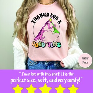 May include: A pink t-shirt with a graphic of a praying mantis eating a green bug. The graphic is inside a circle with the text "Thanks for a Good Time" in rainbow colors.