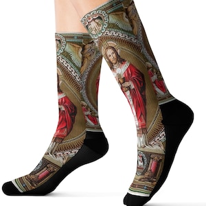 May include: A pair of black socks with a colorful design featuring a religious scene. The design includes a figure of Jesus Christ in a red robe, holding a chalice. The background is a mosaic of gold, green, and blue.