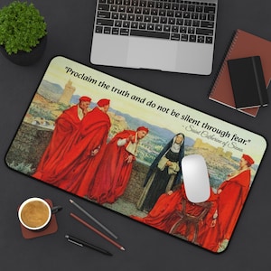 May include: A rectangular mousepad featuring a Renaissance-style painting of figures in red robes and a nun. The mousepad has the quote "Proclaim the truth and do not be silent through fear." - Saint Catherine of Siena.