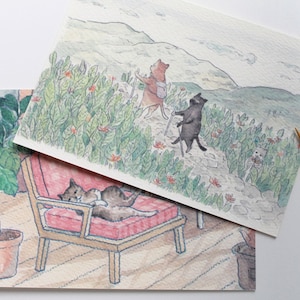 Un conjunto de 2 postales de gatos: excursión y bronceado