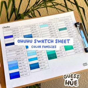 May include: A color swatch sheet from Ohuhu, featuring various shades of blue and green. The sheet is held on a wooden clipboard and includes color families like "Muted Blue Purples" and "Ice Blue Greens." The text "OHUHU SWATCH SHEET COLOR FAMILIES" is visible.
