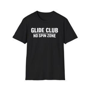 May include: Black t-shirt with the white text "GLIDE CLUB" above "NO SPIN ZONE". The short-sleeved shirt is made of a soft material and is suitable for casual wear. The shirt is a crew neck style.