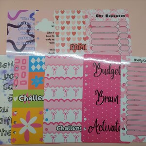 May include: A selection of pink planner inserts with various patterns and text. Designs include hearts, bows, and floral motifs. Text includes "Budget", "Challenge", and "Yearly Occasions". These inserts are for planning and organisation.