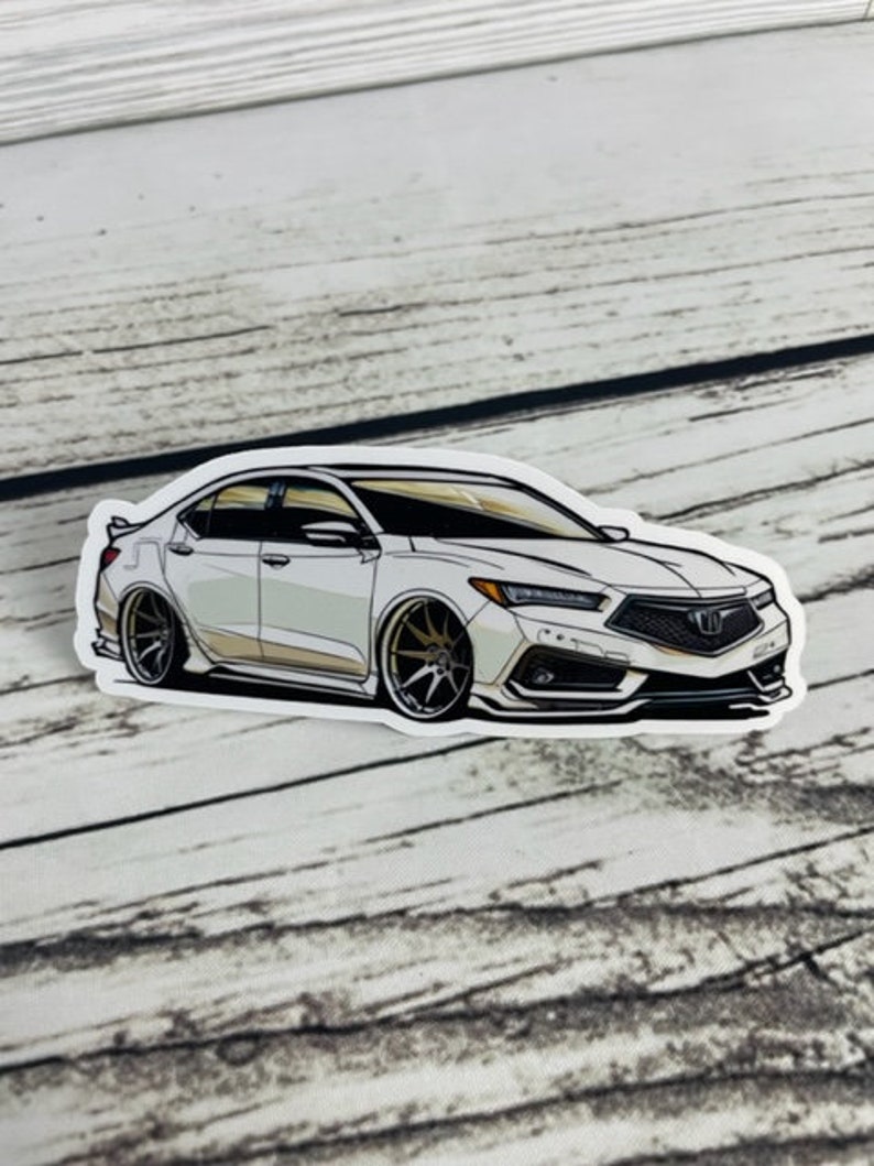 May include: White car sticker featuring a detailed illustration of a white saloon car with black accents and gold wheels. The car has a black grille with a silver Honda logo.