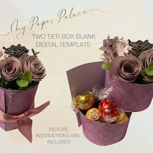 May include: A two-tiered paper box template with a purple and white floral design. The box is decorated with a pink ribbon and is filled with chocolate candies. The text "My Paper Palace" and "TWO TIER BOX BLANK DIGITAL TEMPLATE" is visible on the image. The text "PICTURE INSTRUCTIONS ARE INCLUDED" is also visible.