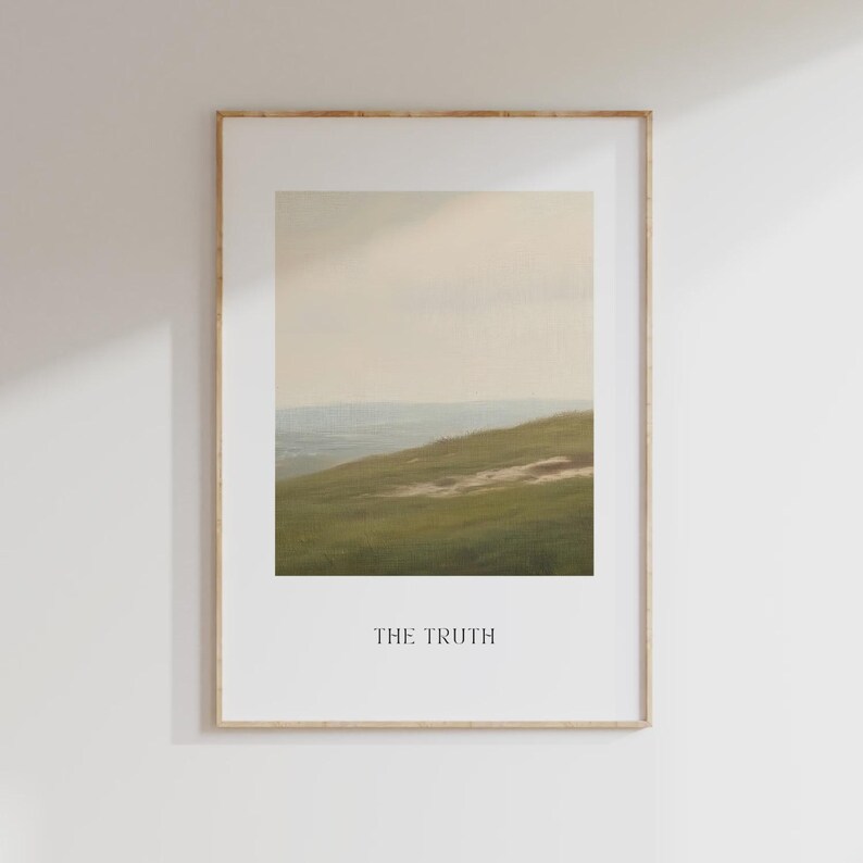 May include: Framed landscape art print featuring a serene hillside scene with green grass and a distant horizon under a soft, cloudy sky. The print is in a wooden frame and includes the text "THE TRUTH" at the bottom.