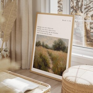 May include: A framed print with a quote from the Bible, Ruth 1:16, "Where you go I will go, where you stay I will stay. Your people will be my people and your God my God." The print features a painting of a path through a field of tall grass.