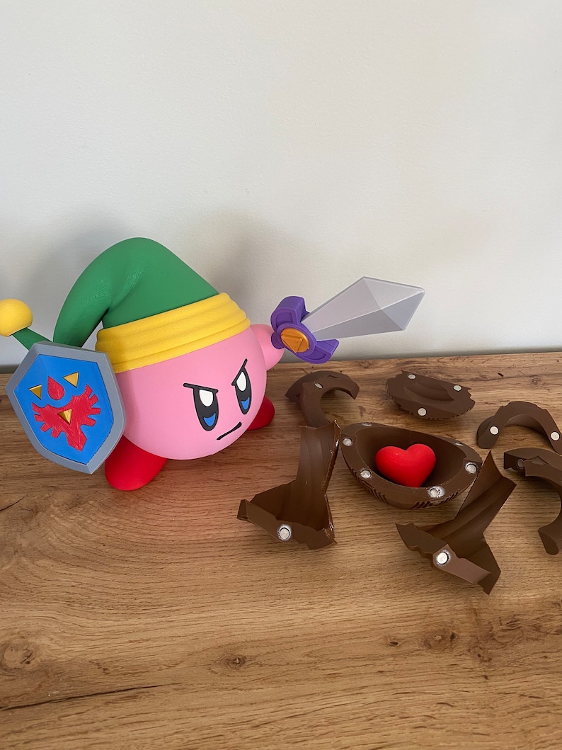 May include: A pink and green character holding a sword and shield. The character is standing on a wooden surface. There are several brown pieces of a puzzle scattered around the character. One piece of the puzzle has a red heart inside.