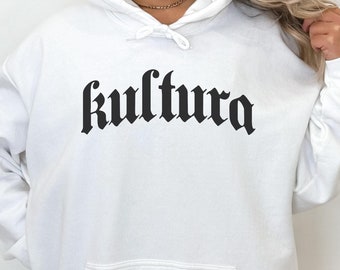 May include: White hooded sweatshirt with the word "kultura" printed in black gothic font.