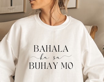 May include: White sweatshirt with the text "BAHALA ka sa BUHAY MO" printed on the front.
