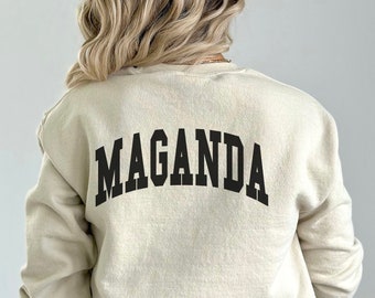 May include: A sand-coloured sweatshirt with the word "MAGANDA" printed in black on the back.