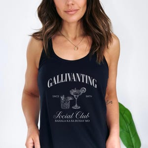 May include: Navy blue tank top with the text "GALLIVANTING Social Club" and illustrations of two cocktails. The text "SINCE" and "BIRTH" are above the cocktail illustrations. The text "BAHALA KA SA BUHAY MO" is below the Social Club text.