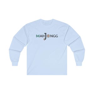 May include: A light blue long-sleeved t-shirt with the text "MAHJONGG" printed in black and green on the front.