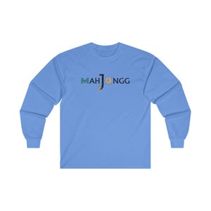 May include: A light blue long-sleeved t-shirt with the text "MAHJONGG" printed in black, green, and red.