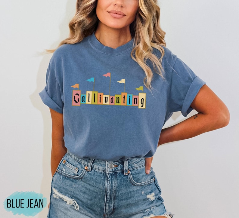 May include: A blue t-shirt with a graphic of colorful flags and the word "Gallivanting" in a vintage font.