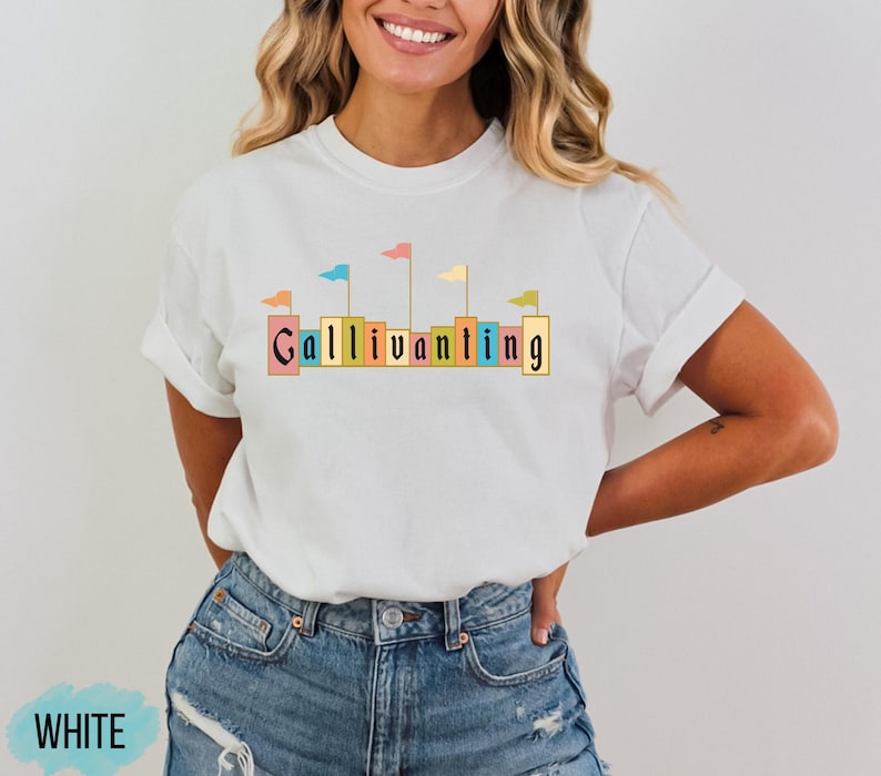 May include: White t-shirt with a graphic of colorful flags and the word "Gallivanting" in a blocky font.