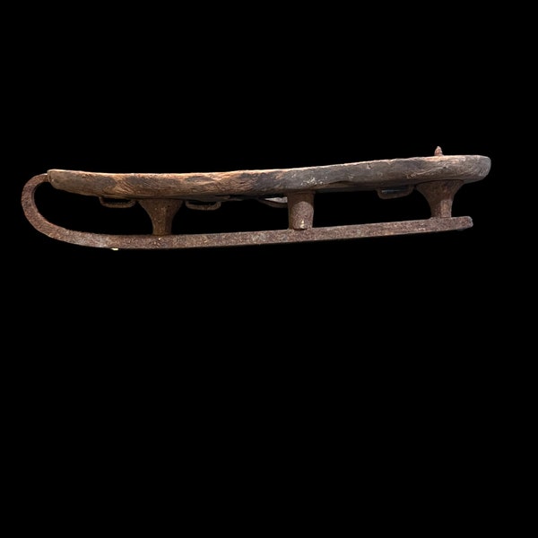 Antique Ice Skate Early 1800’s Wooden Ice skate with metal blade and metal loops on the bottom that were used to run straps through for wear