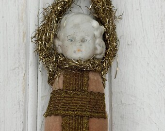 Antique bisque doll ornament with tinsel