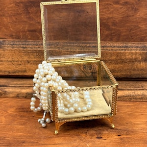 vintage coffin jewelry box.  Beveled glass, gold tone