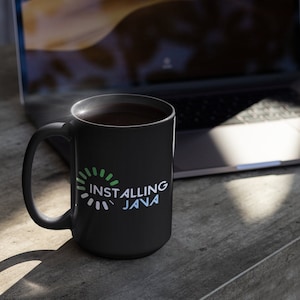 May include: Black coffee mug with a white loading bar graphic and the text "Installing Java".