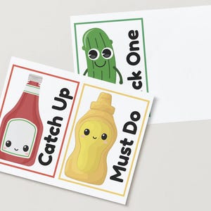 May include: Three illustrated cards with food-themed characters. A red ketchup bottle with the words "Catch Up", a yellow mustard bottle with "Must Do", and a green pickle with "Pick One".