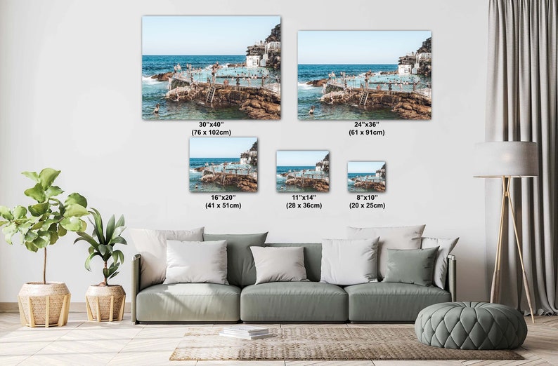 May include: A collage of five different sized photos showing an aerial view of an outdoor pool with people swimming and sunbathing on a rocky island. The photos are arranged in a grid pattern with the largest photo at the top left and the smallest photo at the bottom right. The photos are all in a similar style with a bright blue sky and clear water.