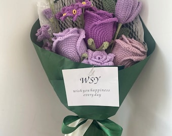 May include: A bouquet of crocheted flowers in shades of purple and green, wrapped in green paper with a white ribbon. The bouquet has a card attached with the text "WSY wish you happiness every day".