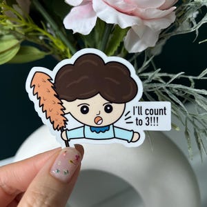 May include: A sticker featuring a cartoon character with brown hair and a blue shirt holding a feather duster. The sticker has the text "I'll count to 3!!!". The background includes pink flowers and greenery.