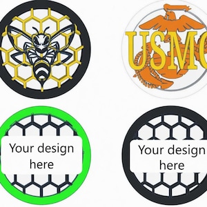 May include: Four circular designs. One features a bee with a honeycomb background. Another displays the USMC emblem. The remaining two have a honeycomb pattern with the text "Your design here" on a white rectangle.