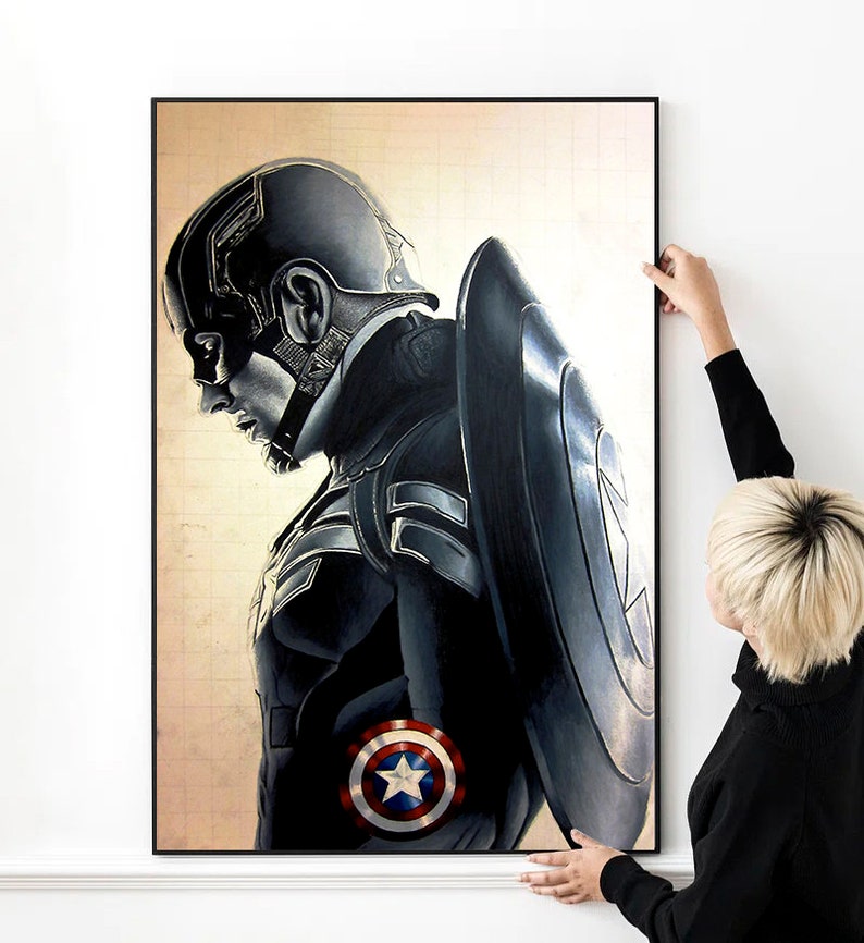 K&ouml;nnte beinhalten: Eine Schwarzwei&szlig;illustration von Captain America, einem Superhelden, mit seinem Schild hinter ihm. Die Illustration ist auf einer Leinwand mit einem Gittermuster.